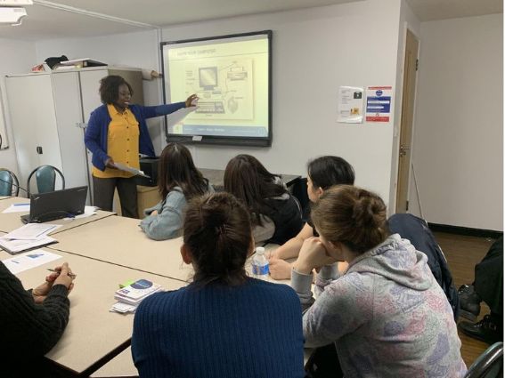 A computer class with a whiteboard